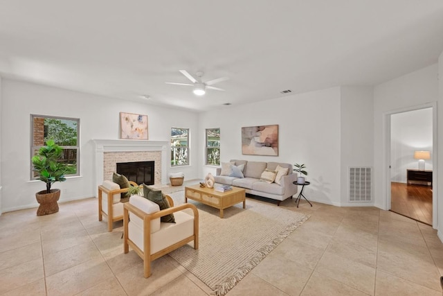 6304 John Chisum Ln, Austin, TX 78749 - living room featuring ceiling fan, light tile patterned flooring, a glass covered fireplace, and baseboards