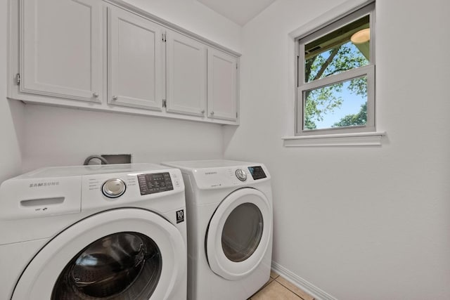 6304 John Chisum Ln, Austin, TX 78749 - laundry room with cabinet space, washer and dryer, baseboards, and light tile patterned flooring
