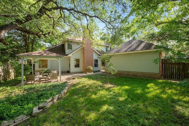 6304 John Chisum Ln, Austin, TX 78749 - back of house with a chimney, a patio area, and roof with shingles