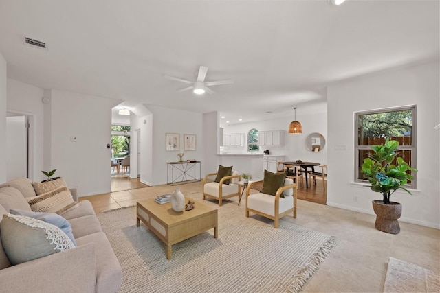 6304 John Chisum Ln, Austin, TX 78749 - living room with a ceiling fan, light tile patterned floors, and baseboards