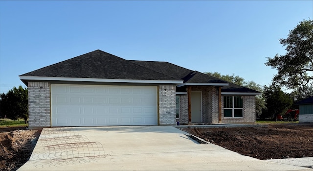 108 Aidan Ct, Burnet, TX 78611 - single story home featuring brick siding, concrete driveway, a garage, and roof with shingles