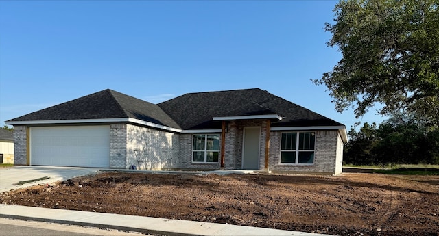 108 Aidan Ct, Burnet, TX 78611 - view of front facade with brick siding, a garage, and driveway