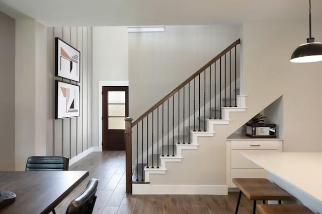 237 Regatta Trl, Leander, TX 78641 - stairs featuring wood finished floors, baseboards, and a towering ceiling
