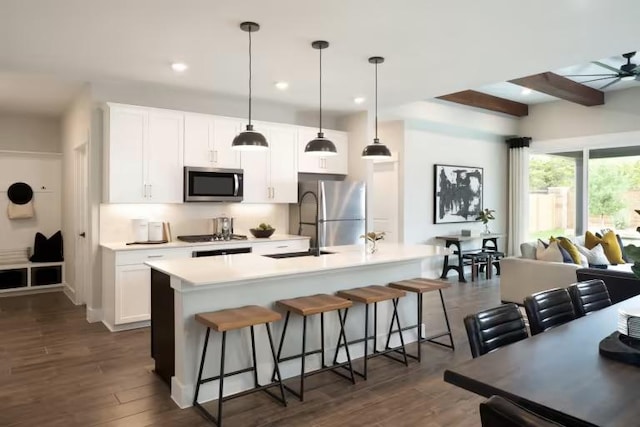 237 Regatta Trl, Leander, TX 78641 - kitchen featuring appliances with stainless steel finishes, a kitchen breakfast bar, light countertops, white cabinetry, and recessed lighting