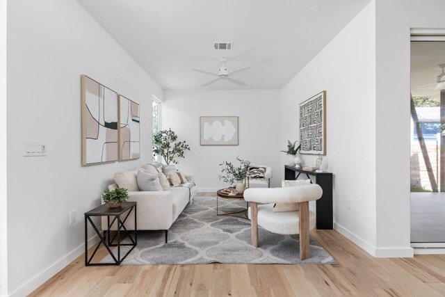 2903 Breeze Ter Unit 1, Austin, TX 78722 - living area with wood finished floors, plenty of natural light, baseboards, and a ceiling fan