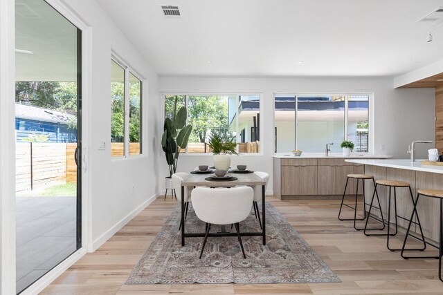2903 Breeze Ter Unit 1, Austin, TX 78722 - dining space with light wood-type flooring and baseboards