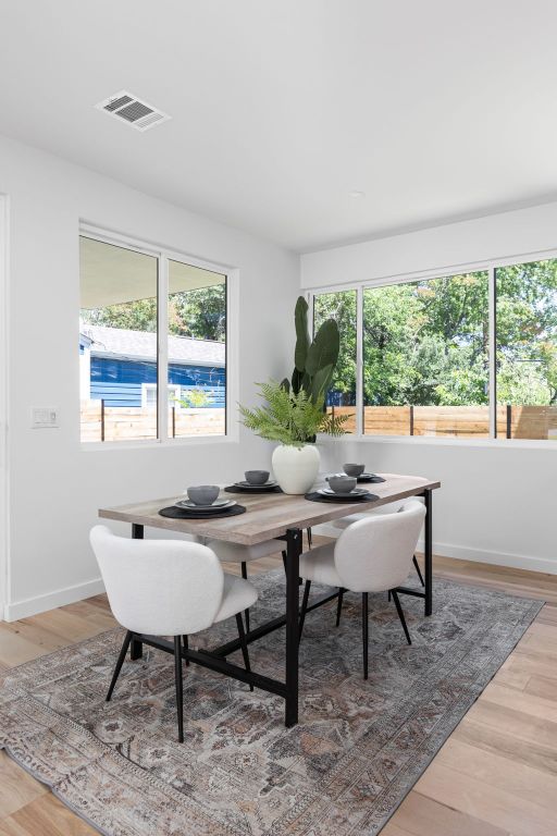 2903 Breeze Ter Unit 1, Austin, TX 78722 - dining area featuring wood finished floors and baseboards