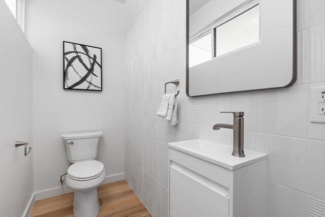 2903 Breeze Ter Unit 1, Austin, TX 78722 - half bathroom featuring toilet, vanity, wood finished floors, and baseboards