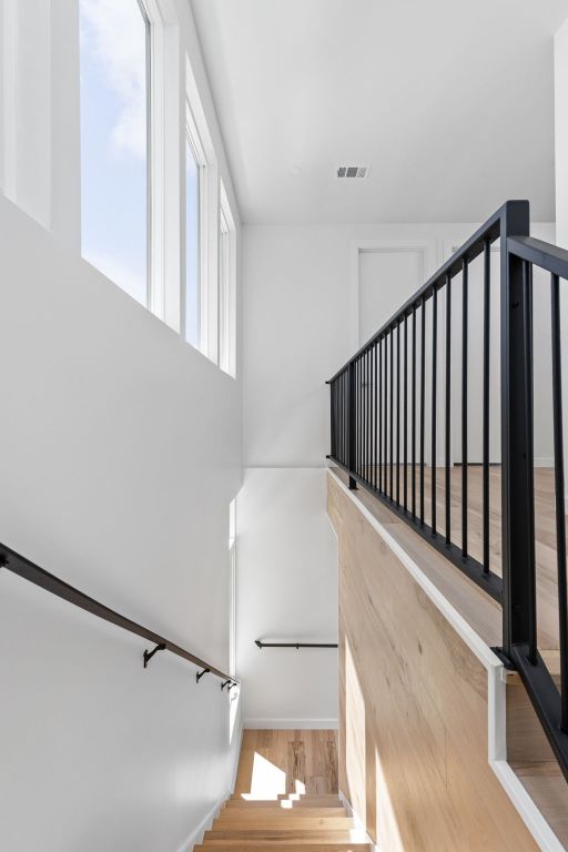 2903 Breeze Ter Unit 1, Austin, TX 78722 - stairway featuring wood finished floors