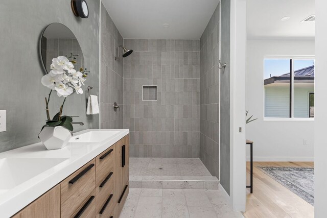 2903 Breeze Ter Unit 1, Austin, TX 78722 - full bathroom with tiled shower, double vanity, and baseboards