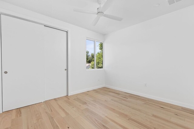 2903 Breeze Ter Unit 1, Austin, TX 78722 - unfurnished bedroom with light wood-style floors, a closet, baseboards, and ceiling fan