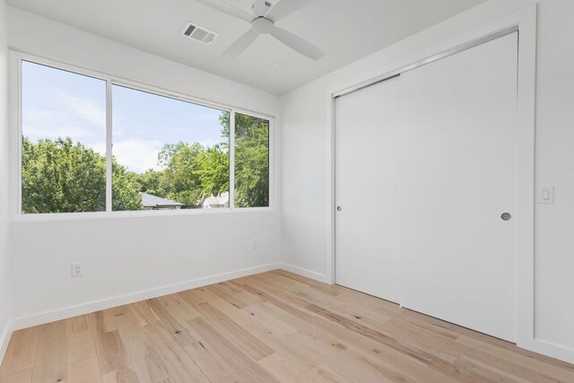 2903 Breeze Ter Unit 1, Austin, TX 78722 - unfurnished bedroom featuring light wood-style floors, a closet, baseboards, and a ceiling fan