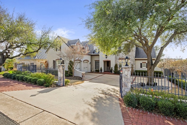 124 Florentine, Horseshoe Bay, TX 78657 - view of front of house featuring driveway, a fenced front yard, stucco siding, and a tile roof