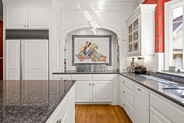 124 Florentine, Horseshoe Bay, TX 78657 - kitchen with paneled fridge, light wood-style flooring, glass insert cabinets, and white cabinets