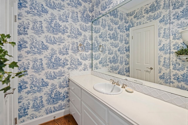 124 Florentine, Horseshoe Bay, TX 78657 - bathroom featuring wallpapered walls, vanity, wood finished floors, and baseboards