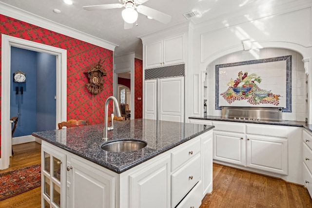 124 Florentine, Horseshoe Bay, TX 78657 - kitchen with a sink, wood finished floors, paneled refrigerator, ornamental molding, and white cabinets