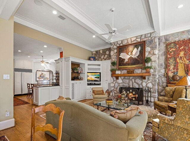 124 Florentine, Horseshoe Bay, TX 78657 - living room featuring a ceiling fan, a fireplace, crown molding, light wood-type flooring, and recessed lighting