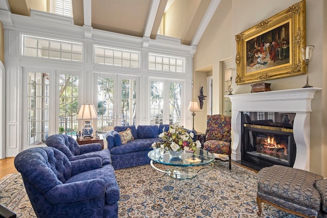 124 Florentine, Horseshoe Bay, TX 78657 - living area featuring a high ceiling, healthy amount of natural light, french doors, a fireplace with flush hearth, and beam ceiling