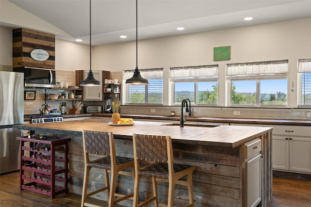 2124 Crabapple Rd, Blanco, TX 78606 - kitchen with butcher block counters, open shelves, appliances with stainless steel finishes, a sink, and decorative backsplash