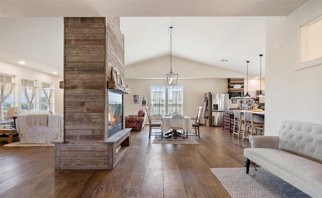 2124 Crabapple Rd, Blanco, TX 78606 - living room with a glass covered fireplace, dark wood-style floors, and lofted ceiling