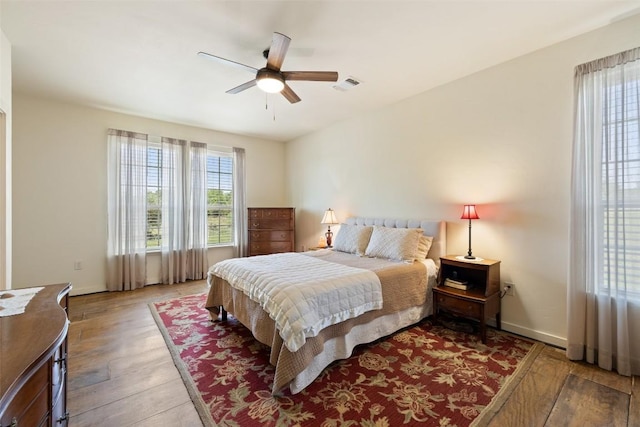 2124 Crabapple Rd, Blanco, TX 78606 - bedroom featuring wood-type flooring, baseboards, and a ceiling fan