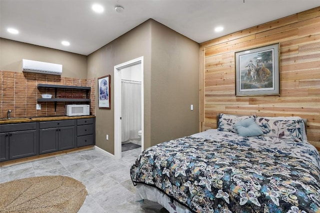 2124 Crabapple Rd, Blanco, TX 78606 - bedroom featuring a sink, a wall unit AC, recessed lighting, wood walls, and ensuite bathroom