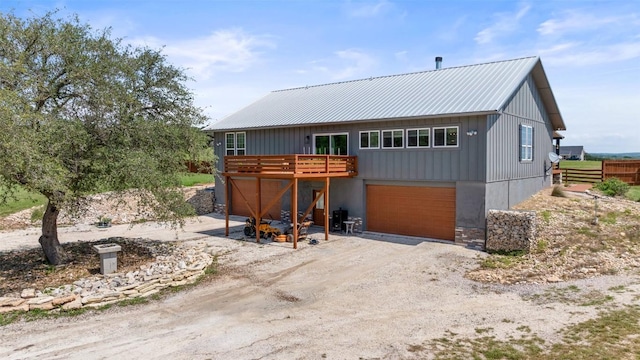 2124 Crabapple Rd, Blanco, TX 78606 - back of house with a wooden deck, driveway, metal roof, a garage, and fence
