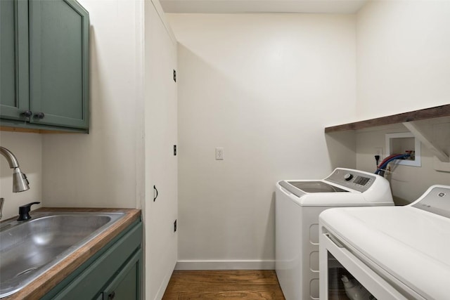 2124 Crabapple Rd, Blanco, TX 78606 - laundry area with washer and clothes dryer, cabinet space, dark wood-style flooring, and baseboards