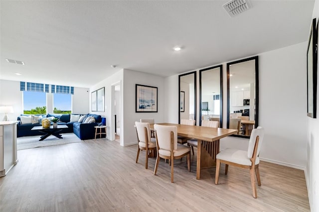 1006 Antelope Trl, Temple, TX 76504 - dining area featuring light wood-type flooring, a wall of windows, and baseboards
