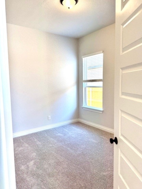 999 N Roger Hanks Pkwy, Dripping Springs, TX 78620 - carpeted spare room featuring baseboards and a textured ceiling