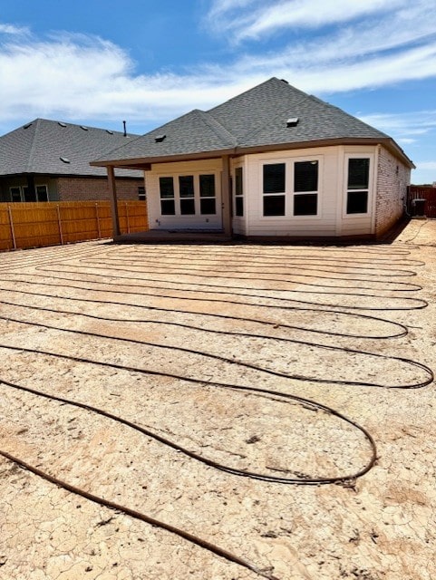 999 N Roger Hanks Pkwy, Dripping Springs, TX 78620 - rear view of property featuring fence, a wooden deck, and roof with shingles