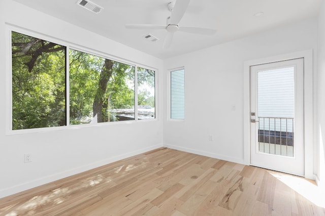 unfurnished room featuring baseboards, ceiling fan, and light wood-type flooring