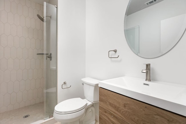 full bathroom featuring toilet, a stall shower, and vanity