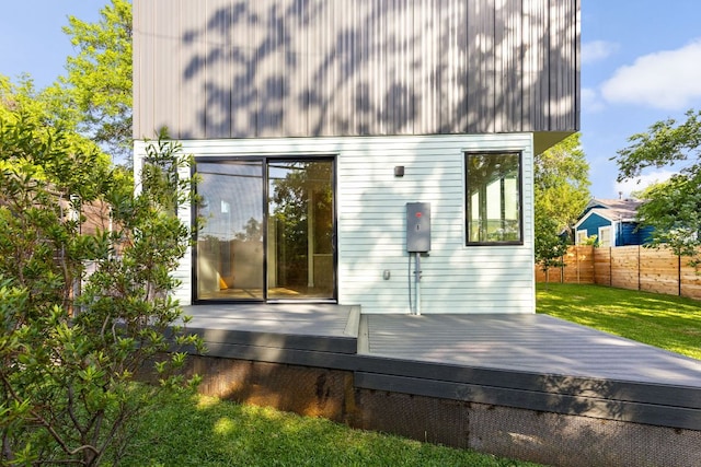 rear view of house featuring a wooden deck
