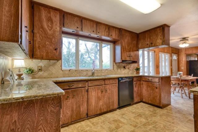 508 Lee St N, Round Rock, TX 78664 - kitchen featuring black dishwasher, brown cabinetry, a sink, and a peninsula