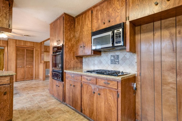 508 Lee St N, Round Rock, TX 78664 - kitchen with gas cooktop, tasteful backsplash, brown cabinets, a warming drawer, and oven