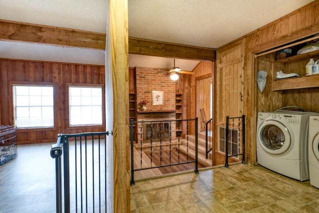 508 Lee St N, Round Rock, TX 78664 - laundry room with wood walls, washer and clothes dryer, a textured ceiling, and ceiling fan