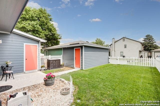 5659 Fergus Unit A, Kyle, TX 78640 - fenced backyard featuring a patio and a storage unit