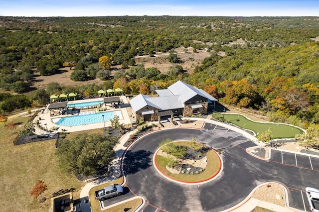 aerial view of a heavily wooded area and a pool