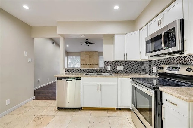 10400 Burmaster Ln Unit A, Austin, TX 78750 - kitchen featuring appliances with stainless steel finishes, a sink, decorative backsplash, white cabinetry, and a ceiling fan