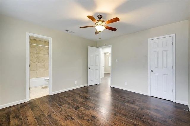10400 Burmaster Ln Unit A, Austin, TX 78750 - unfurnished bedroom featuring dark wood-style floors, baseboards, connected bathroom, and ceiling fan
