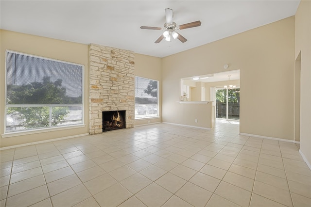 10400 Burmaster Ln Unit A, Austin, TX 78750 - unfurnished living room with light tile patterned floors, a ceiling fan, baseboards, a fireplace, and a chandelier