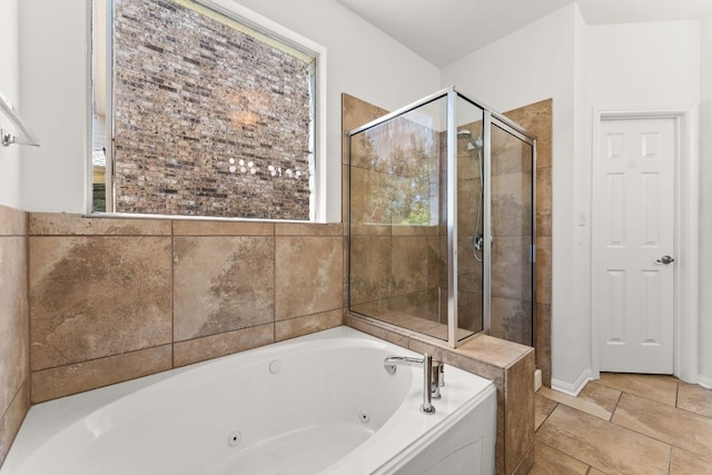 12501 Rush Creek Ln, Austin, TX 78732 - full bath featuring healthy amount of natural light, a jetted tub, a stall shower, and tile patterned floors