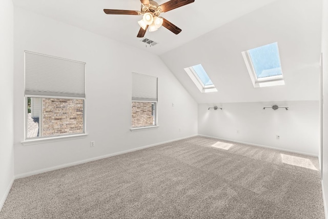 12501 Rush Creek Ln, Austin, TX 78732 - additional living space with a skylight, lofted ceiling, carpet floors, baseboards, and ceiling fan
