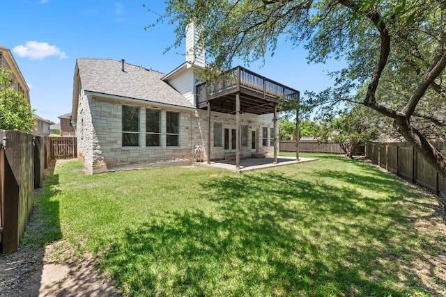 12501 Rush Creek Ln, Austin, TX 78732 - back of property featuring stone siding, a patio area, a chimney, roof with shingles, and a wooden deck