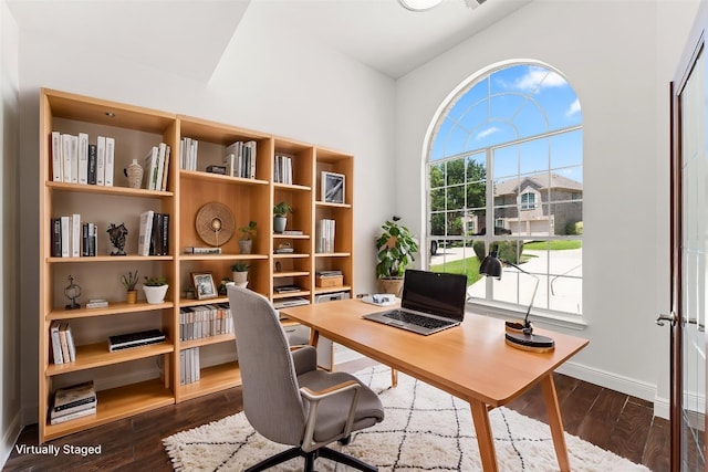 12501 Rush Creek Ln, Austin, TX 78732 - office area with dark wood finished floors, baseboards, and a towering ceiling