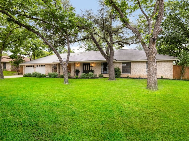 2300 Toulouse Dr, Austin, TX 78748 - single story home featuring a garage, stone siding, concrete driveway, and metal roof
