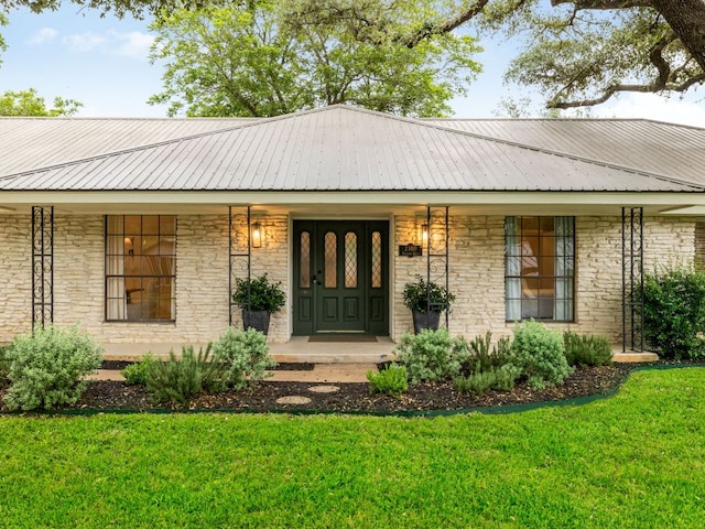 2300 Toulouse Dr, Austin, TX 78748 - entrance to property with covered porch, a yard, metal roof, and stone siding