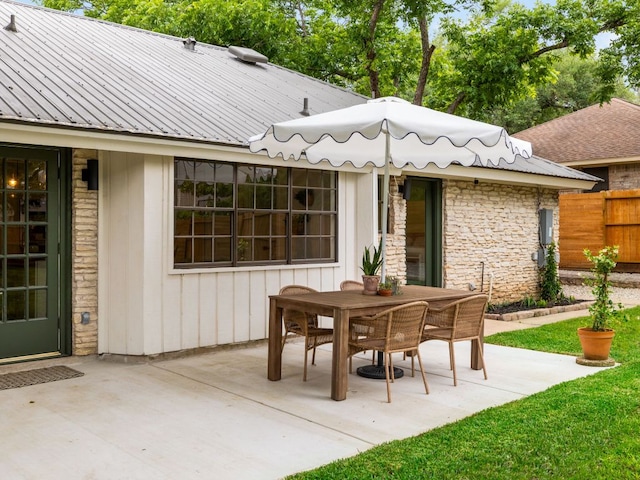 view of patio featuring fence and outdoor dining space