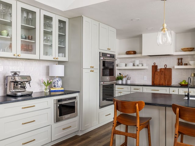 2300 Toulouse Dr, Austin, TX 78748 - kitchen featuring stainless steel double oven, open shelves, tasteful backsplash, and dark countertops